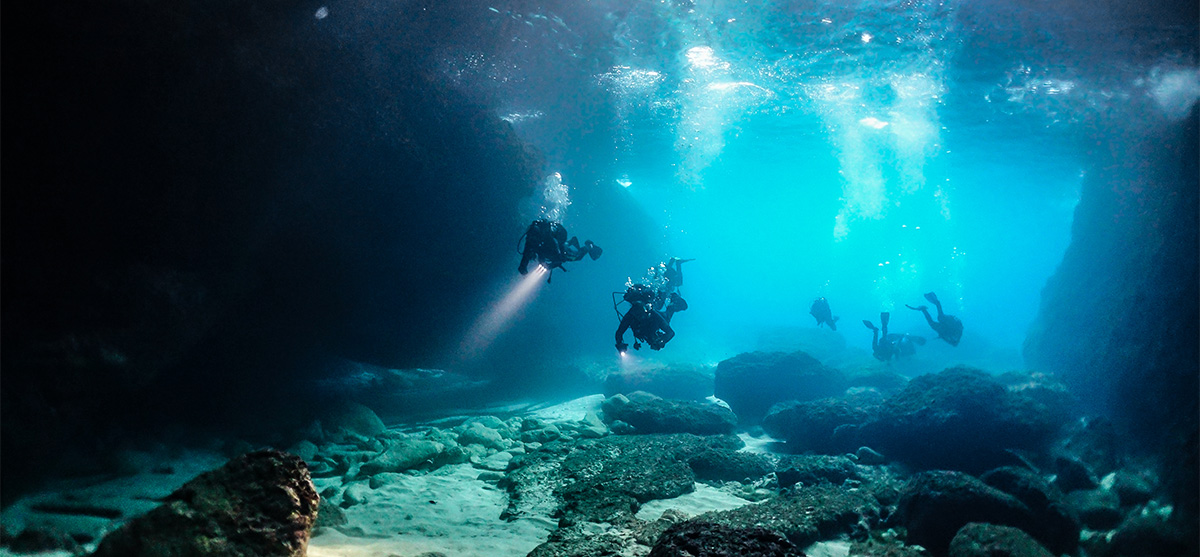 Group of divers cave diving in Malta