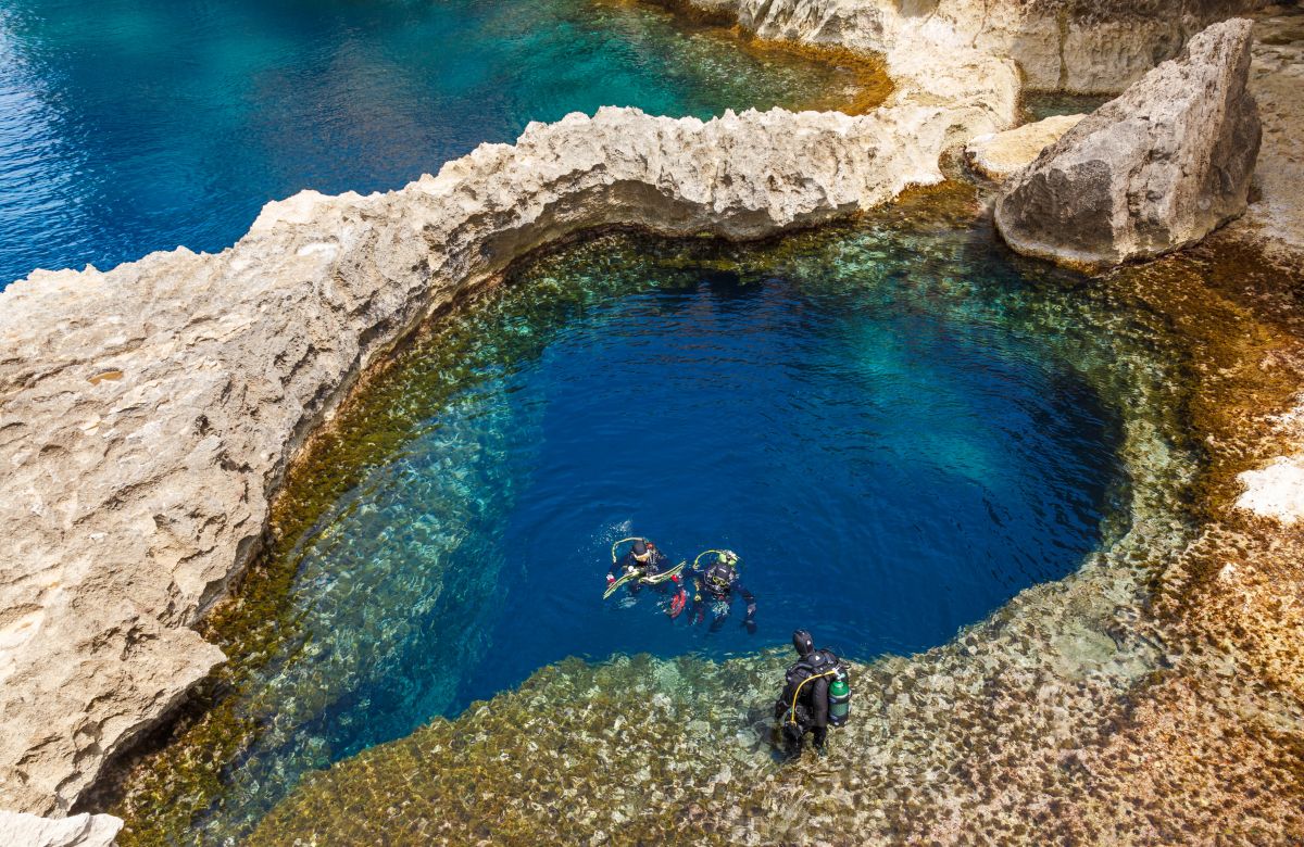 Divers emerging from the Blue Hole dive site in Malta