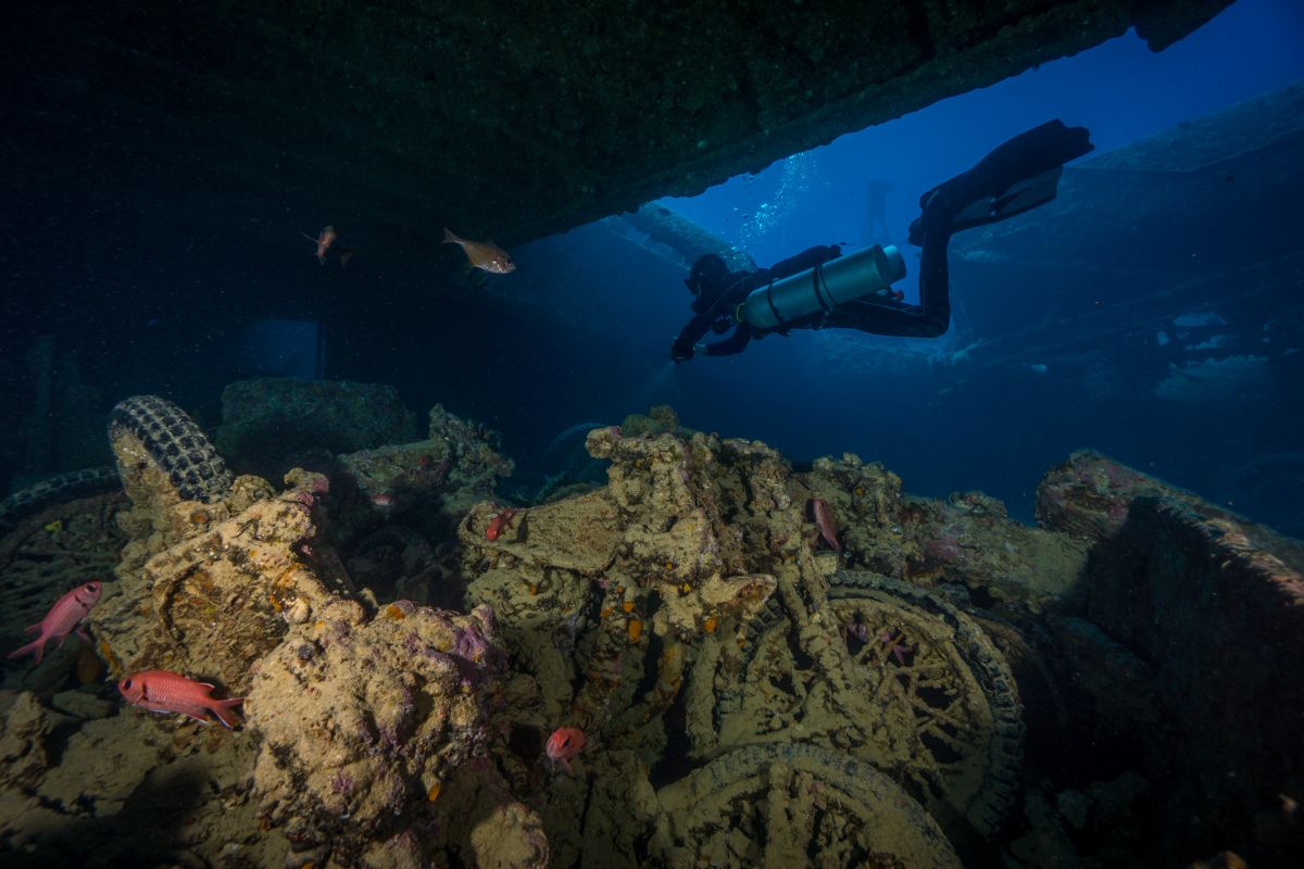 Diver exploring the motorbikes on the Thistlegorm Wreck near Ras Muhammad in the Red Sea, Egypt