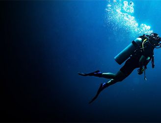 Scuba diver underwater with lots of bubbles around them