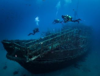 Divers by wreck in St Andrews, Gozo, Malta