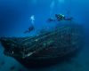 Divers by wreck in St Andrews, Gozo, Malta