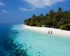 Couple on a beach at Vilamendhoo Resort in the Maldives