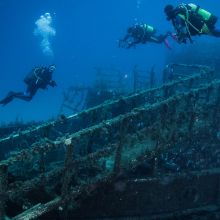 Divers by wreck in St Andrews, Gozo, Malta