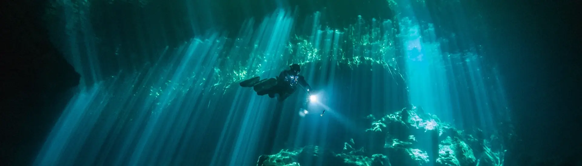 Diver exploring Ponderosa cenotes in Mexico