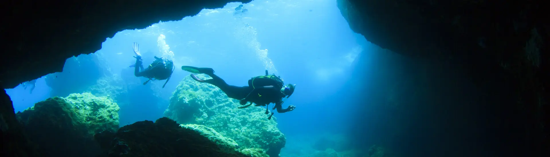Divers investigating a cave in Malta