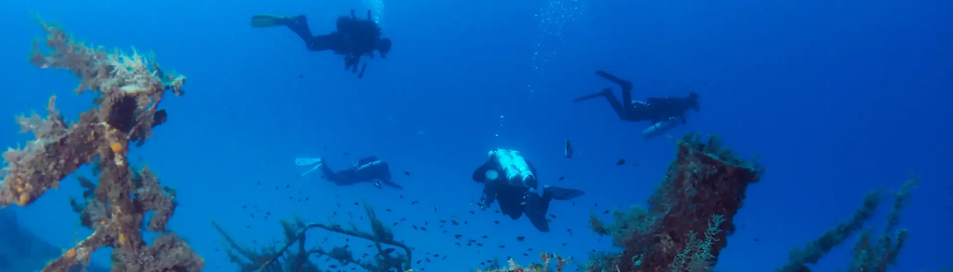 Divers exploring a shipwreck in Gozo