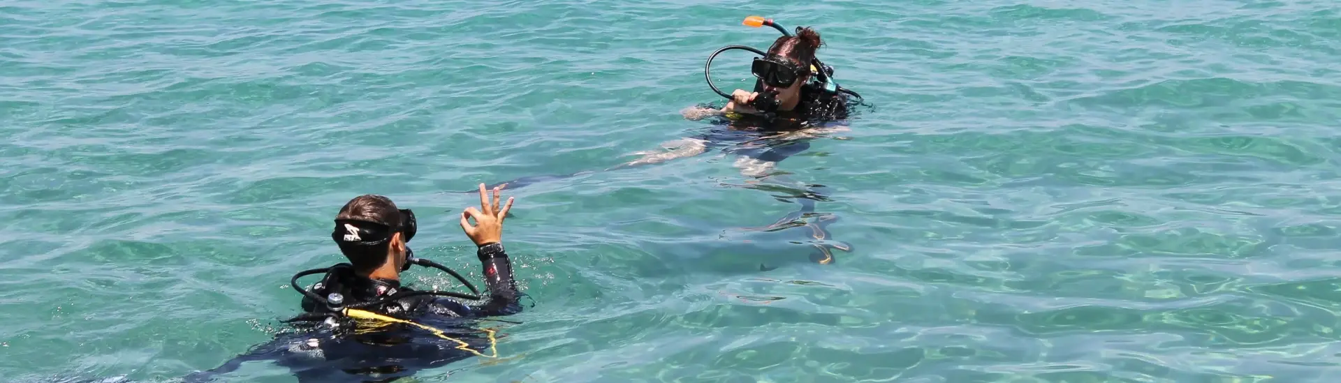 Student being taught by a dive instructor how to dive in Malta
