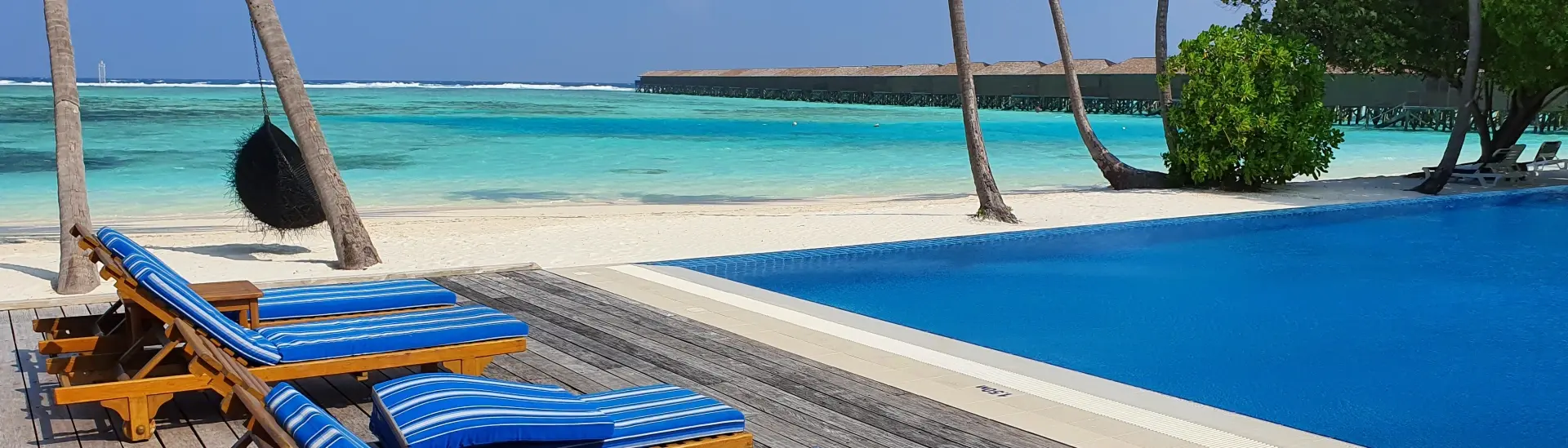 Sun loungers around the swimming pool at Meeru Resort in the Maldives