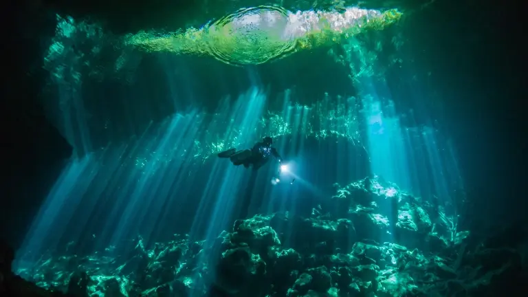Diver exploring Ponderosa cenotes in Mexico
