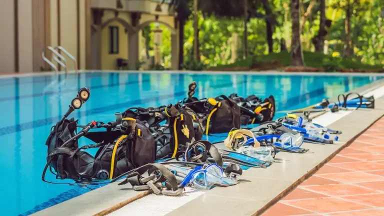 Diving gear by the edge of a swimming pool