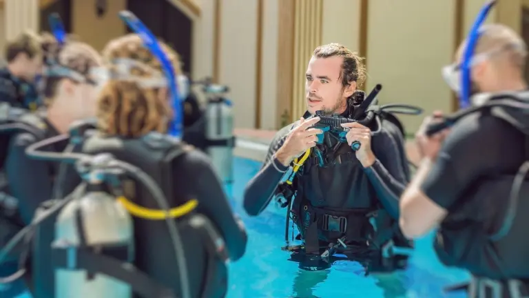 Diving instructor teaching students in a swimming pool in Egypt, the Red Sea