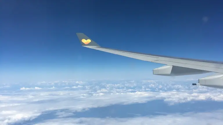 Wing of a Thomas Cook plane in flight