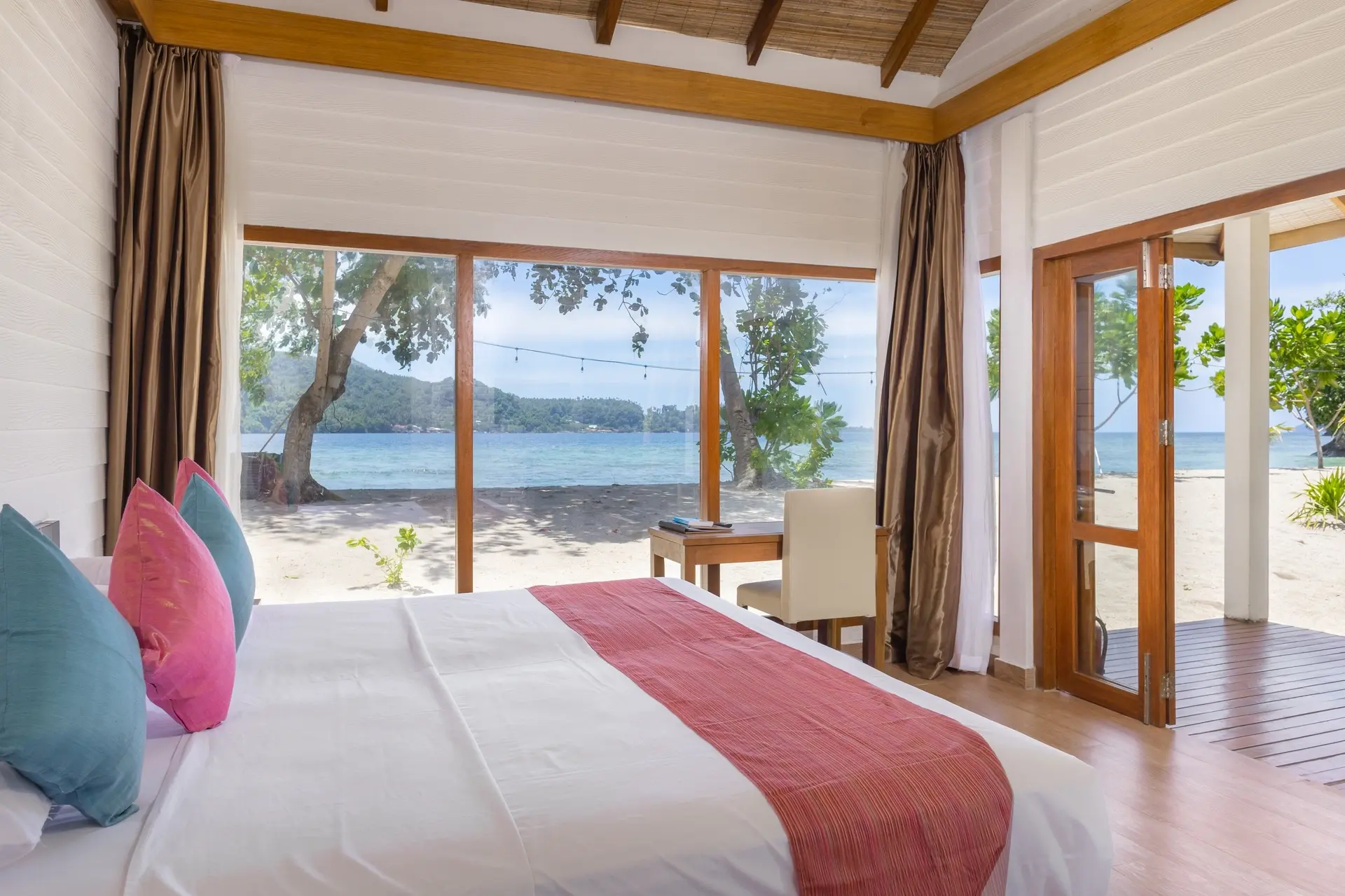 Oceanfront cottage bedroom at White Sands Beach Resort in Lembeh, Indonesia