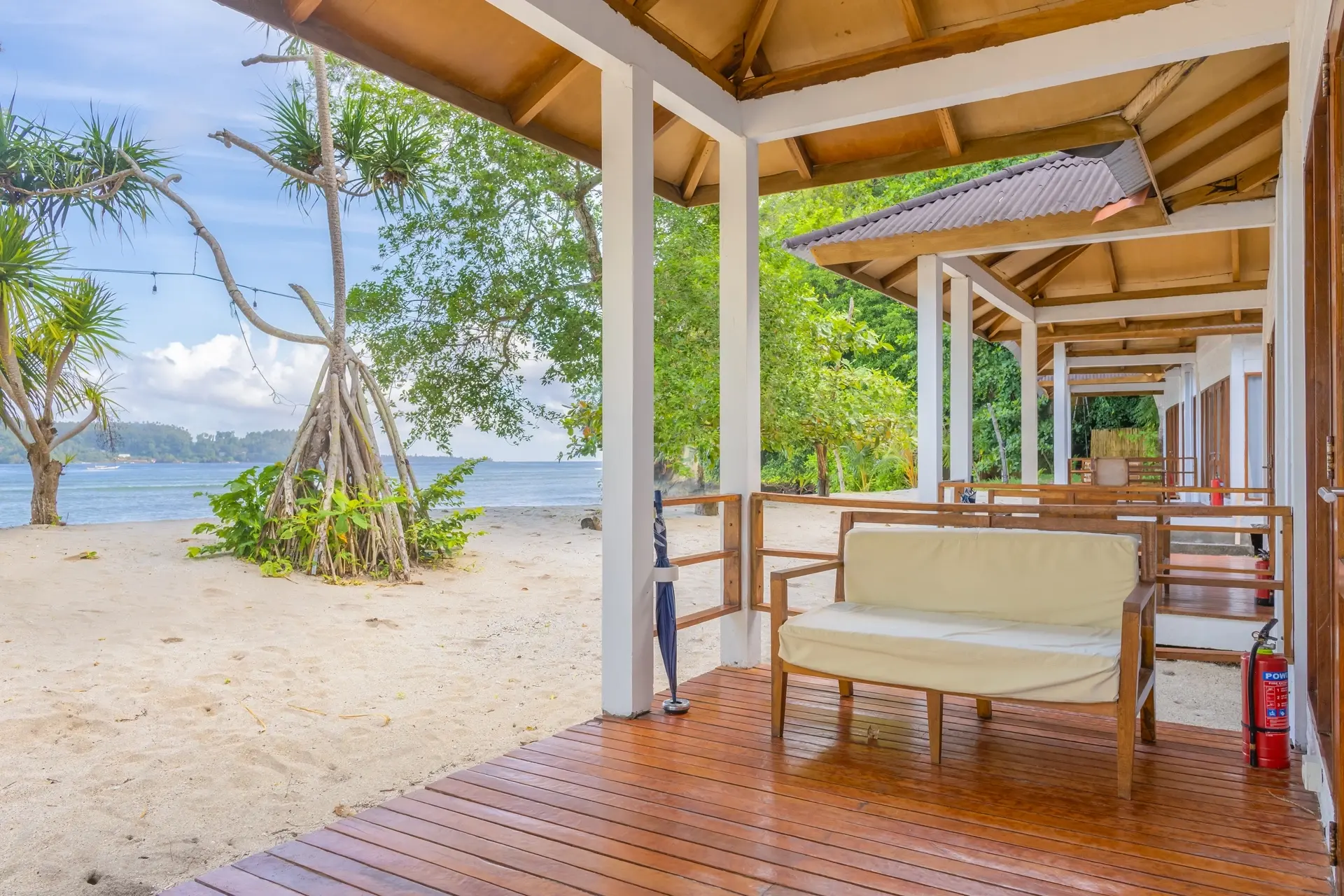 Oceanfront cottage terrace at White Sands Beach Resort in Lembeh, Indonesia