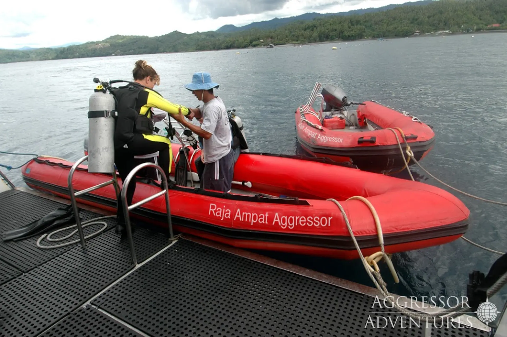 Diver embarking on a Raja Ampat Aggressor zodiac, in Indonesia.