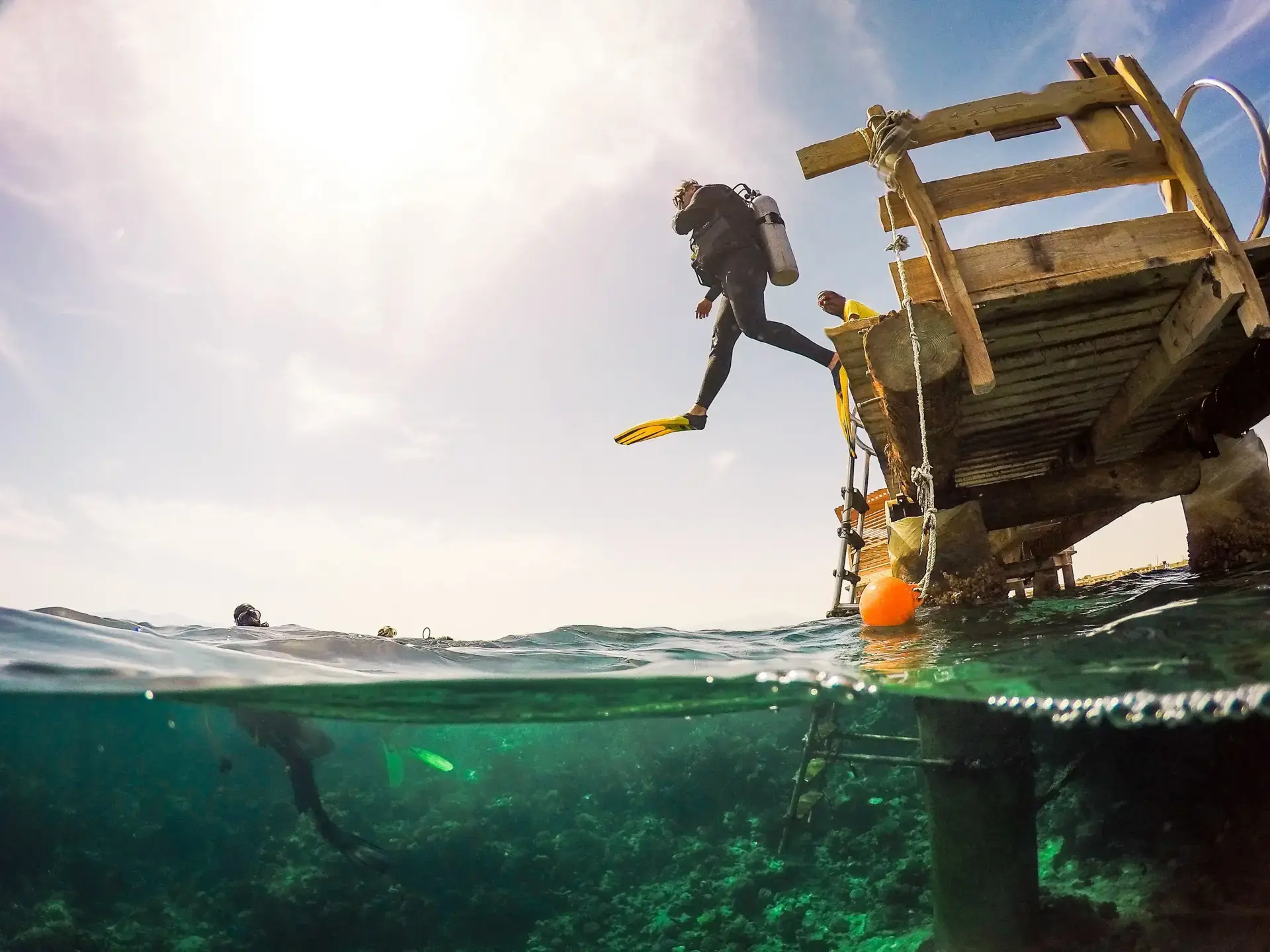 Diver jumping from the jetty at The Breakers Diving & Surf Lodge in Soma Bay, Egypt