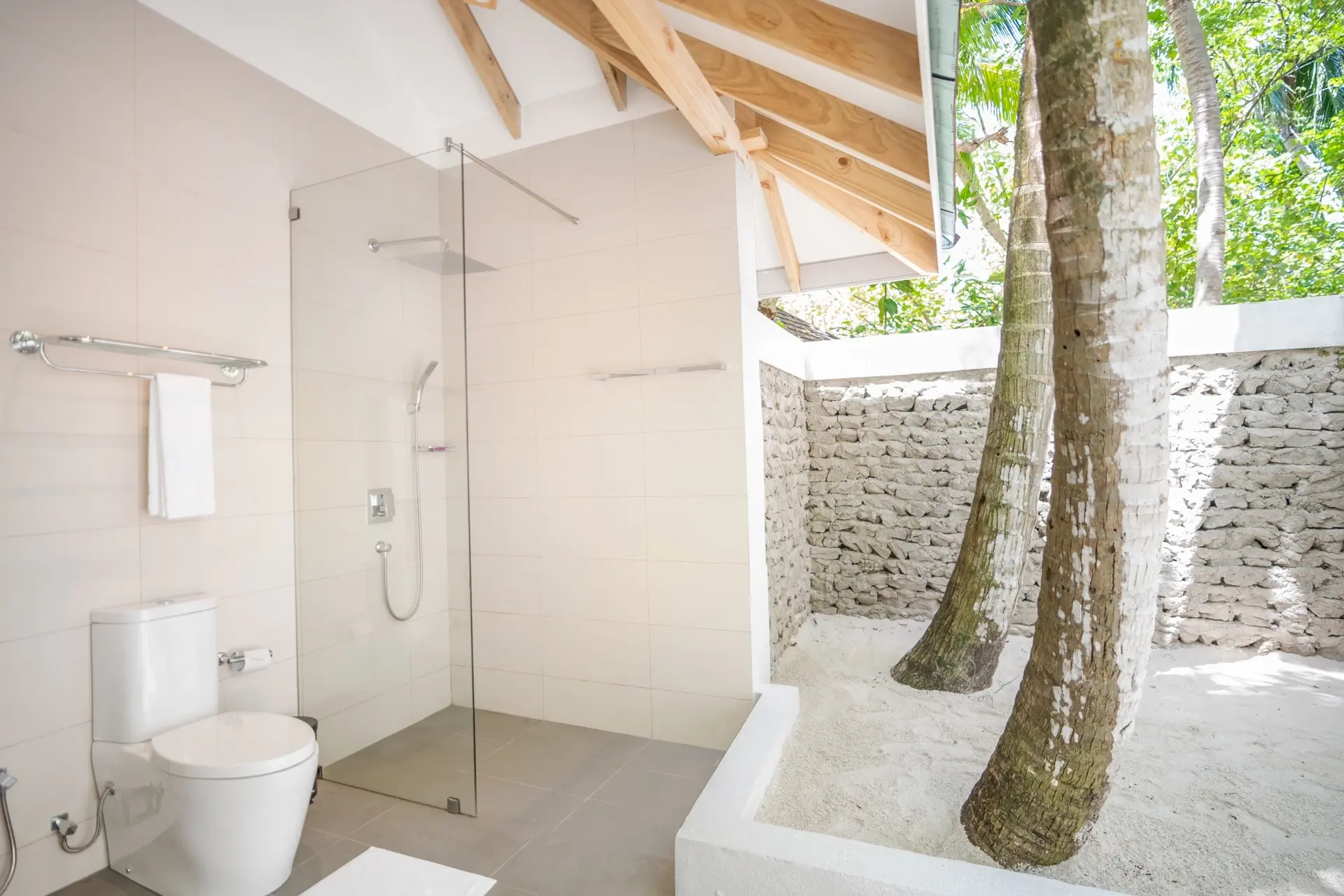 Beach bungalow bathroom at Ellaidhoo Maldives by Cinnamon Resort in the Maldives