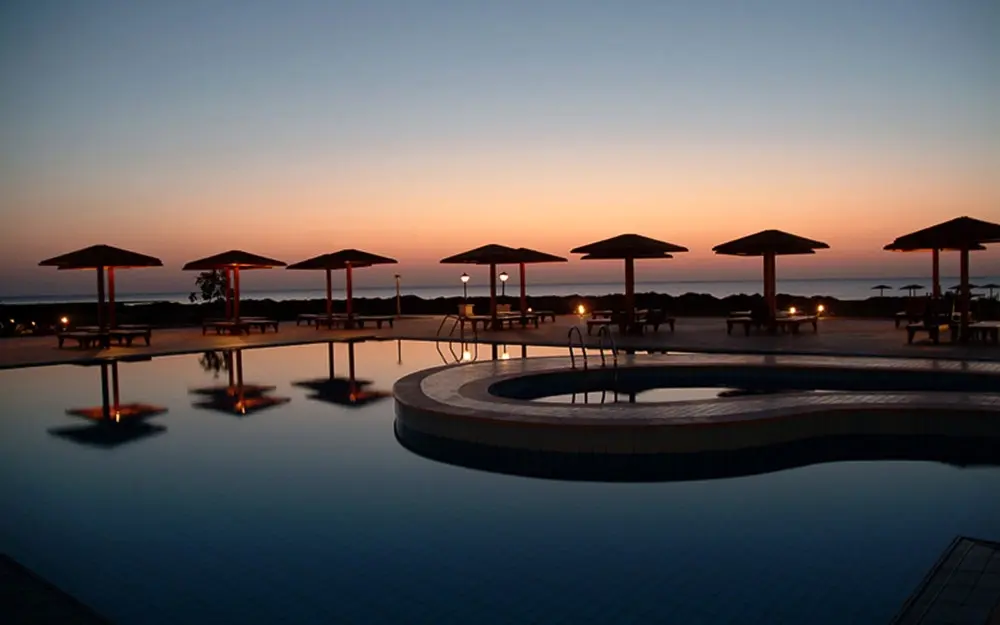 Swimming pool at sunset at Lahami Bay Beach Resort in Hamata, Egypt