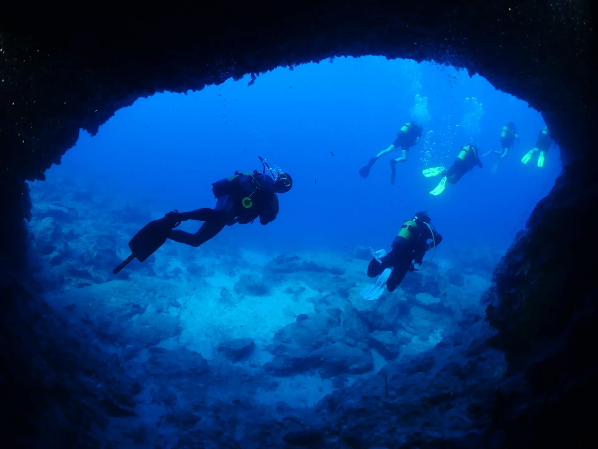 Divers exploring a cave in Malapascua, the Philippines