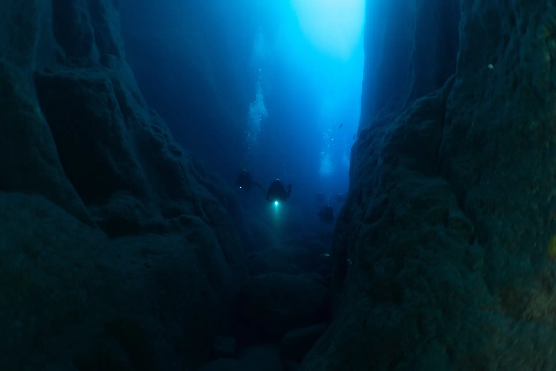 Divers exploring a cave in Pico, the Azores