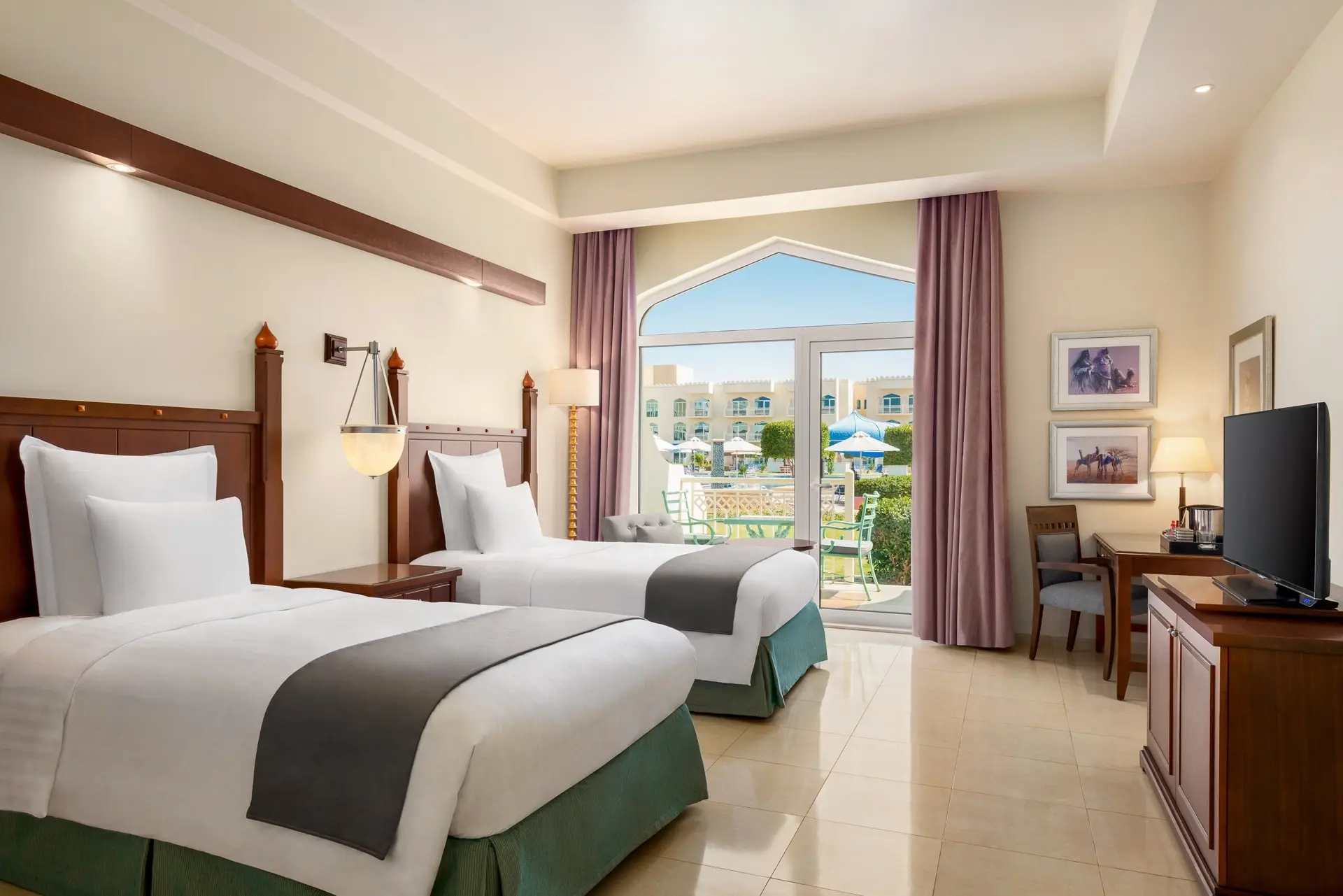 Garden pool view room with twin beds at Wyndham Garden Resort in Mirbat, Oman