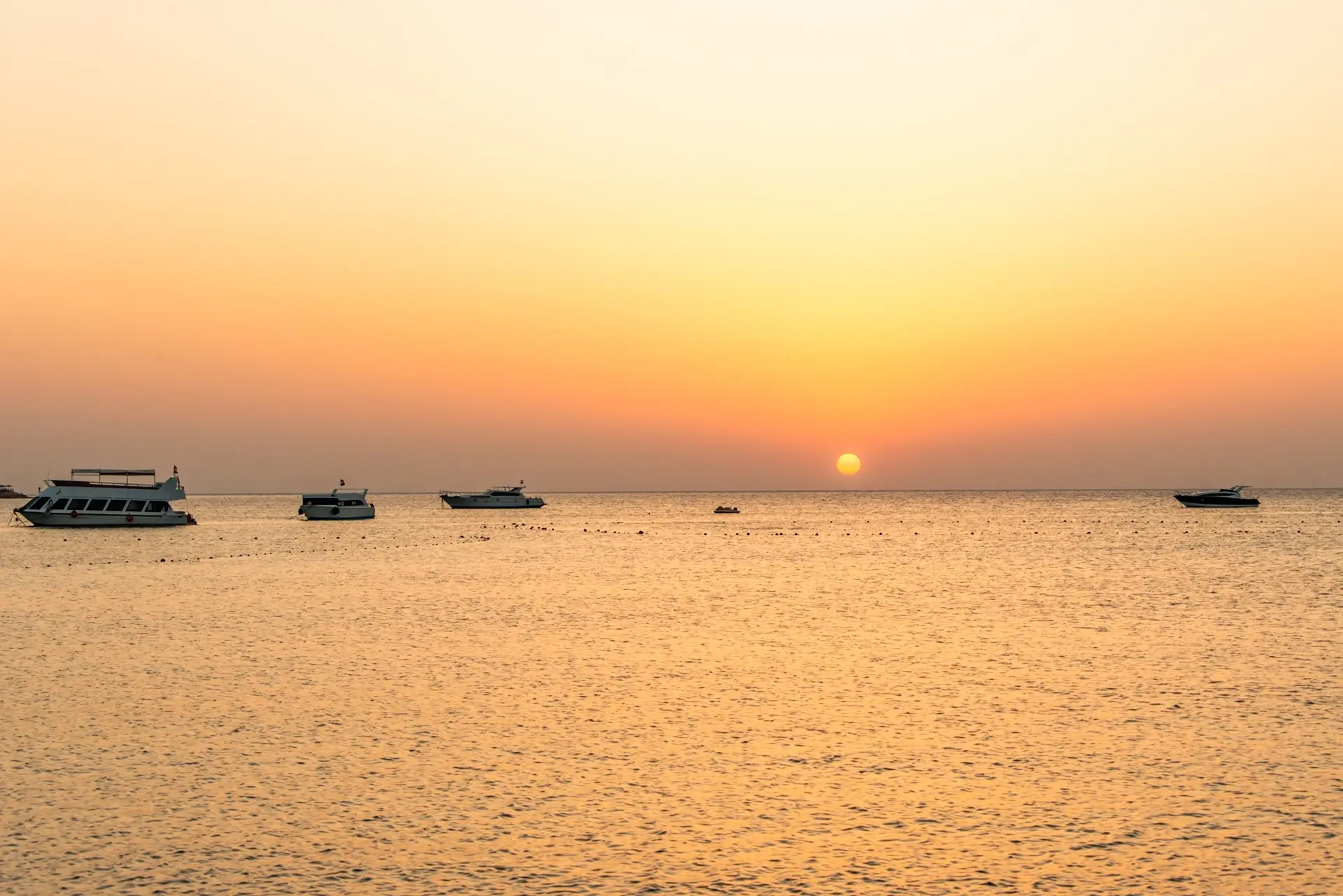 Dive boats at sunset in Makadi Bay, Egypt