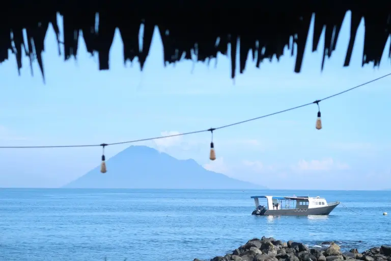 Boat & view of Manado Tua from Murex Manado Resort in Indonesia