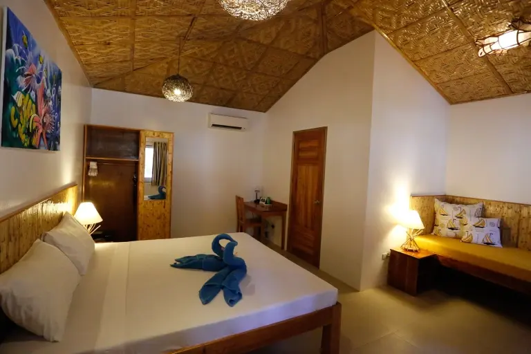 Bungalow bedroom at Magic Oceans Resort in Bohol, the Philippines