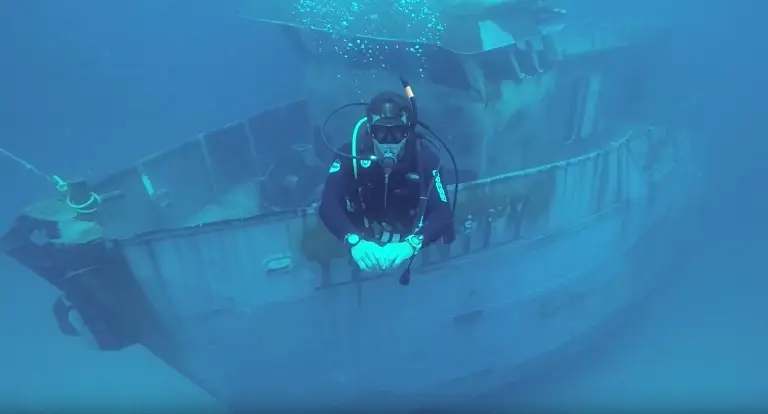 Diver exploring a shipwreck in Speyside, Tobago