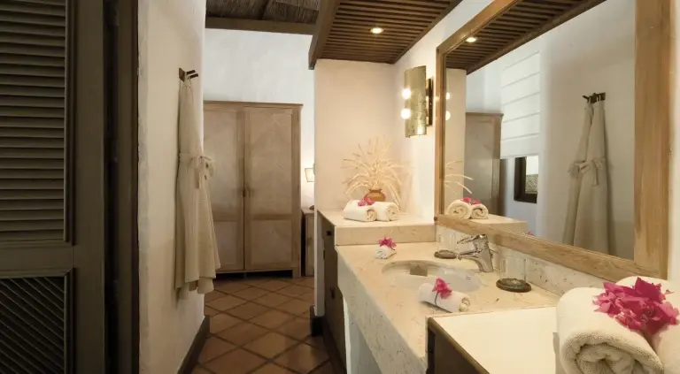 A beach villa bedroom at Coco Palm Dhuni Kolhu Resort, Maldives