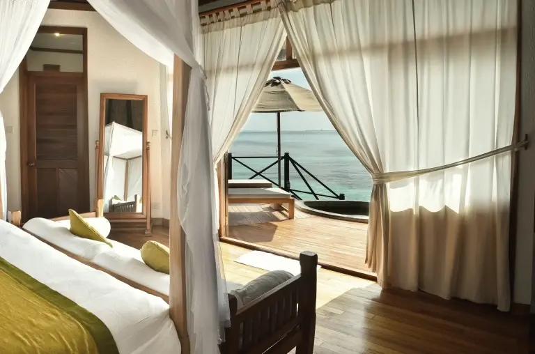 A lagoon villa bedroom at Coco Palm Dhuni Kolhu Resort, Maldives