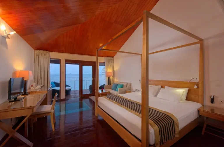 Overwater villa bedroom at Embudu Village accommodation in the Maldives