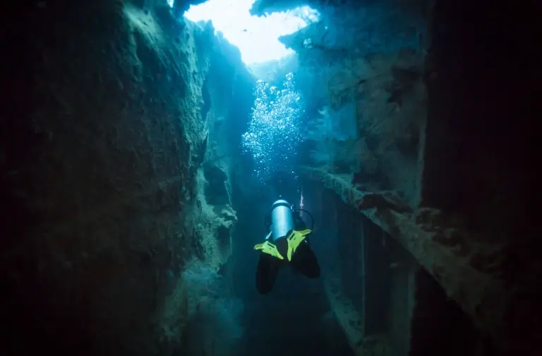 Diver exploring a World War II shipwreck in Coron, the Philippines