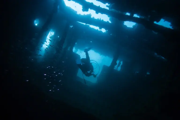 Diver exploring a World War II shipwreck in Coron, the Philippines