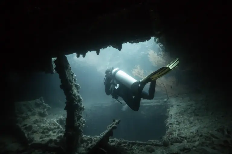 Diver exploring a World War II shipwreck in Coron, the Philippines