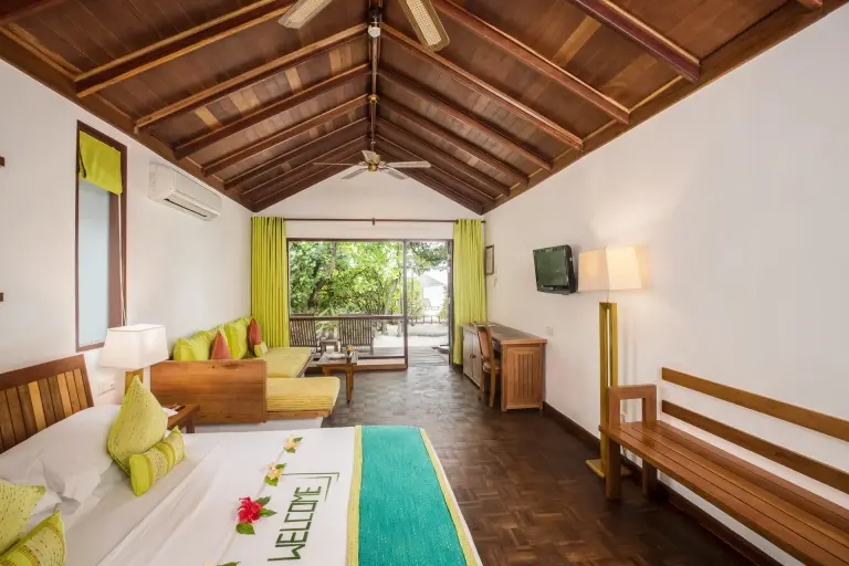 Deluxe villa bedroom at Reethi Beach Resort in the Maldives