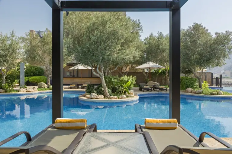 Sun loungers by the swimming pool at Atana Resort in the Musandam Peninsula, Oman